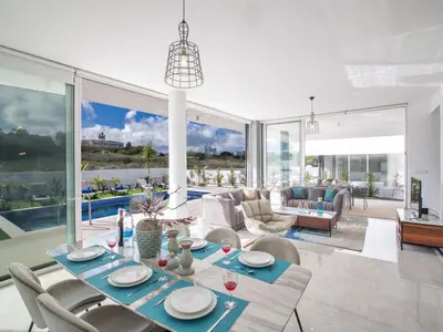 a living room with a dining table and chairs at Villa Olive Sun, Beautiful, Contemporary 3Bdr Villa With Private Pool in Protaras