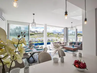 a living room with a white table and chairs at Villa Olive Sun, Beautiful, Contemporary 3Bdr Villa With Private Pool in Protaras