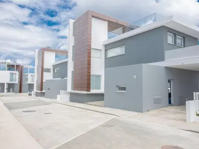 a large white building in a parking lot at Villa Olive Platinum, New And Luxury 4Bdr Protaras Villa With Private Pool in Protaras