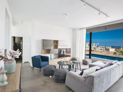 a living room with a view of the ocean at Villa Olive Platinum, New And Luxury 4Bdr Protaras Villa With Private Pool in Protaras