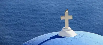 a bird sitting on top of a cross on top at Villa Leoforos Dyo, Modern 3Bdr Protaras Villa With Pool, In The Centre in Protaras