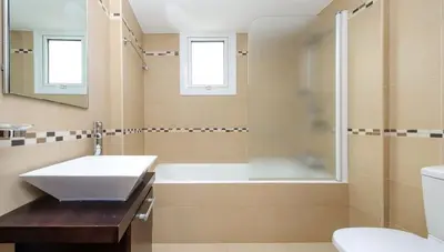 a bathroom with a tub and a sink and a shower at Villa Leoforos Dyo, Modern 3Bdr Protaras Villa With Pool, In The Centre in Protaras