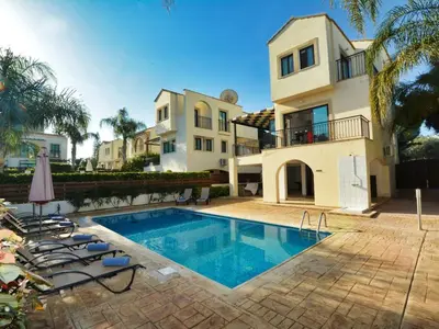 a villa with a swimming pool in front of a house at Villa Protaras Paralia Spacious 4Bdr Central Protaras Villa in Protaras
