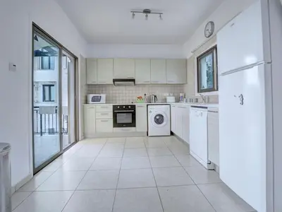 a kitchen with white appliances and a large window at Villa Protaras Paralia Spacious 4Bdr Central Protaras Villa in Protaras