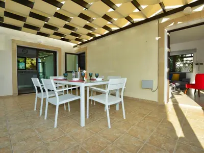 a dining room with a white table and white chairs at Villa Protaras Paralia Spacious 4Bdr Central Protaras Villa in Protaras