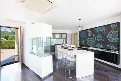 a kitchen with a large white island with bar stools at Villa Protaras Sunshine, Stylish 4Bdr Villa With Pool, Close To Fig Tree in Protaras