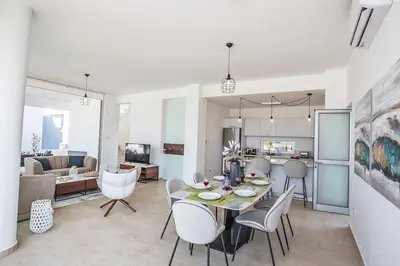 a dining room and living room with a table and chairs at Villa Olive Chrysos, Brand New, Luxury 3 Bdr Protaras Villa, With Private Pool in Protaras
