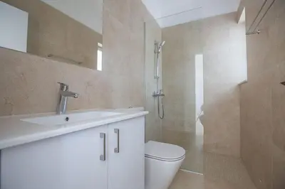 a bathroom with a sink and a toilet and a shower at Villa Olive Chrysos, Brand New, Luxury 3 Bdr Protaras Villa, With Private Pool in Protaras