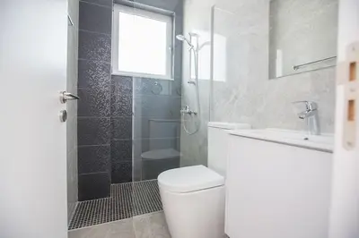a bathroom with a toilet and a shower and a sink at Villa Olive Loux,Brand New, Exquisite 5Bdr Protaras Villa With Pool in Protaras