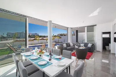 a living room with a table and chairs at Villa Olive Loux,Brand New, Exquisite 5Bdr Protaras Villa With Pool in Protaras
