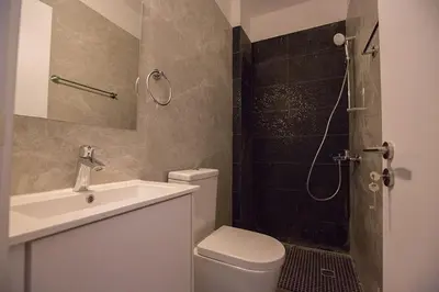 a bathroom with a toilet and a sink and a shower at Villa Olive Loux,Brand New, Exquisite 5Bdr Protaras Villa With Pool in Protaras