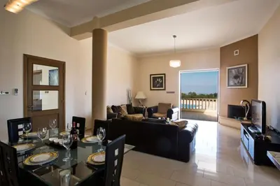 a living room with a table and a couch at Villa Protaras Deluxe, Fabulous And Luxurious 7Bdr Villa, Close To Fig Tree in Protaras