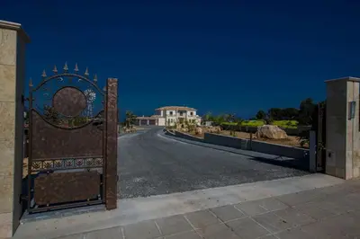 a gate to a driveway with a house in the background at Villa Protaras Deluxe, Fabulous And Luxurious 7Bdr Villa, Close To Fig Tree in Protaras