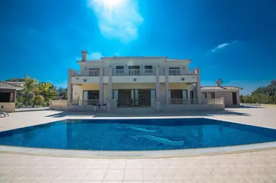a large house with a swimming pool in front of it at Villa Protaras Deluxe, Fabulous And Luxurious 7Bdr Villa, Close To Fig Tree in Protaras