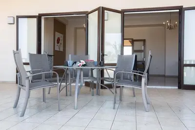 a dining room with a table and chairs at Villa Protaras Deluxe, Fabulous And Luxurious 7Bdr Villa, Close To Fig Tree in Protaras