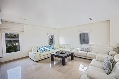 a living room with couches and a coffee table at Villa Fig Tree Bay Frontline,Luxury 4Bdr Sea-Front Protaras Villa With Pool in Protaras