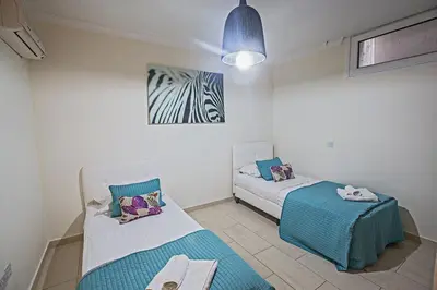 a bedroom with two beds and a zebra picture on the wall at Villa Fig Tree Bay Frontline,Luxury 4Bdr Sea-Front Protaras Villa With Pool in Protaras