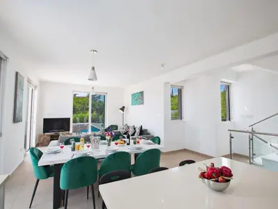 a dining room with a table and green chairs at Villa Protaras Gold,Brand New, Luxury 5Bdr Protaras Villa With Private Pool in Protaras