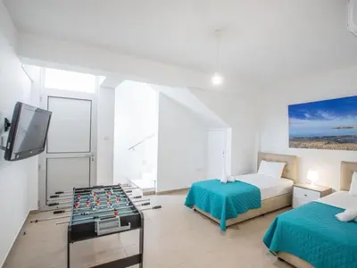 a room with a bed and a foosball at Villa Protaras Gold,Brand New, Luxury 5Bdr Protaras Villa With Private Pool in Protaras
