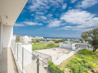 a balcony with a view of the ocean at Villa Protaras Gold,Brand New, Luxury 5Bdr Protaras Villa With Private Pool in Protaras