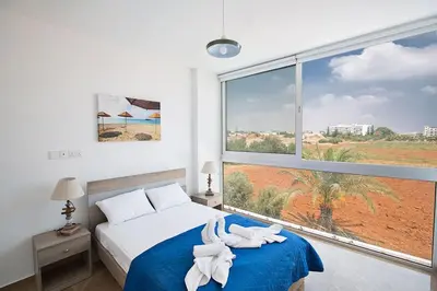 a bedroom with a bed and a large window at Villa Manta Platina - Brand New Luxury 3 Bedroom Protaras Villa in Protaras