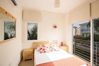 a bedroom with a bed and a large window at Villa Dafnis Sunshine - Modern 3 Bedroom Central Protaras Villa With Pool in Protaras
