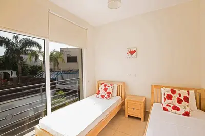 a bedroom with a bed and a large window at Villa Dafnis Sunshine - Modern 3 Bedroom Central Protaras Villa With Pool in Protaras
