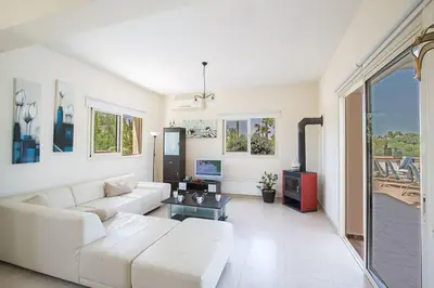 a living room with a white couch and a table at Villa Akefalo - Beautiful 3 Bedroom Protaras Villa With Private Pool in Protaras