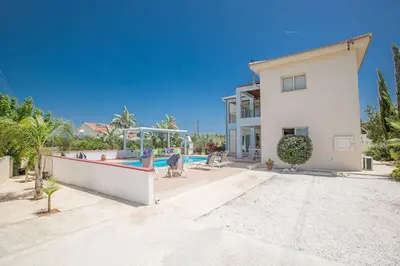a large white house with a swimming pool at Villa Akefalo - Beautiful 3 Bedroom Protaras Villa With Private Pool in Protaras