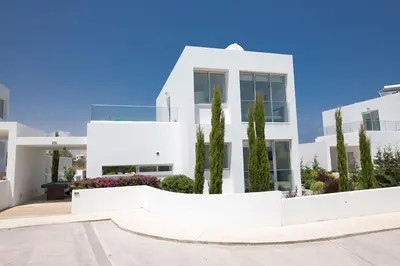 a white house with trees in front of it at Villa Ochosto Helios - Beautiful 5 Bedroom Protaras Villa - Walking Distance in Protaras