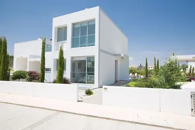 a white house with trees in front of it at Villa Ochosto Helios - Beautiful 5 Bedroom Protaras Villa - Walking Distance in Protaras