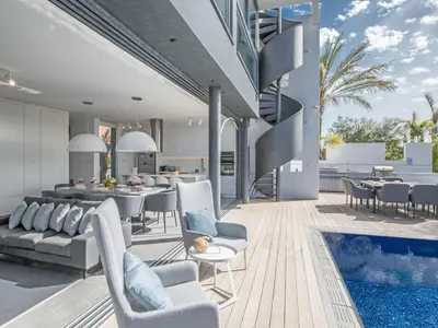 a living room and dining room with a pool at Villa Papadopo - Luxury 3 Bedroom Villa With Private Pool, Hot Tub And Sea Views in Paralimni