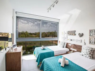 a bedroom with two beds and a large window at Villa Papadopo - Luxury 3 Bedroom Villa With Private Pool, Hot Tub And Sea Views in Paralimni