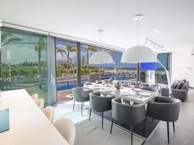 a dining room with a table and chairs at Villa Papadopo - Luxury 3 Bedroom Villa With Private Pool, Hot Tub And Sea Views in Paralimni