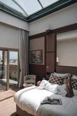 a woman laying on a bed in a bedroom at Leonardo Boutique Hotel Larnaca in Larnaka