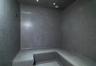 a bathroom with a bath tub in the corner at Leonardo Boutique Hotel Larnaca in Larnaka