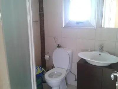 a bathroom with a toilet and a sink at Pallini Court in Protaras