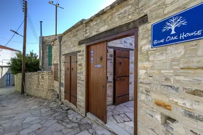 a brick building with two doors and a sign on it at Blue Oak House in Kato Drys