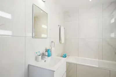 a white bathroom with a sink and a mirror at Villa Nova in Protaras