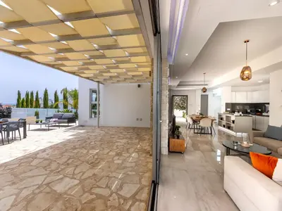 a living room with a couch and a table at Milos lifestyle villas H27 in Protaras