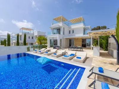 a villa with a swimming pool and a house at Milos lifestyle villas H27 in Protaras