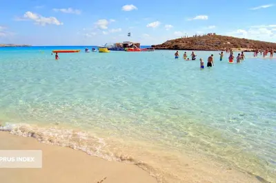 a group of people in the water at a beach at Nissi 3 Pool Access Garden Apartment in Ayia Napa
