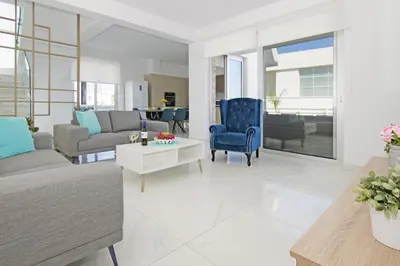 a living room with a couch and a table at Villa Medusa in Protaras
