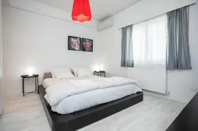 a bedroom with a large bed with white sheets at Mayra Seafront Luxury Apartment (BREAKBOOKING-CY) in Limassol