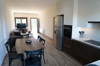 a kitchen and dining room with a table and a refrigerator at Zangoulos Mountain in Kakopetria