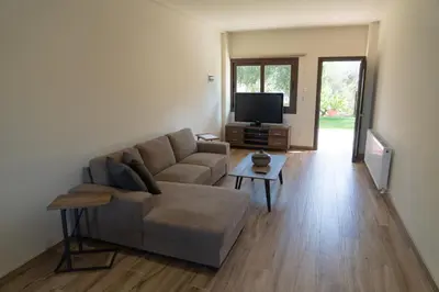 a living room with a couch and a flat screen tv at Zangoulos Mountain in Kakopetria