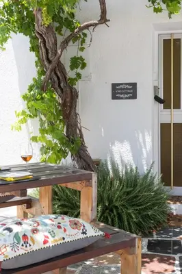 a bench with a pillow sitting in front of a building at LIMASSOL AKROTIRI BEACH VINE COTTAGE a in Limassol