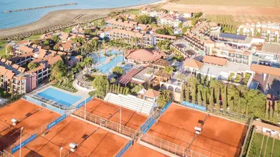 an aerial view of a resort with a tennis court at ROBINSON Cyprus in Alaminos