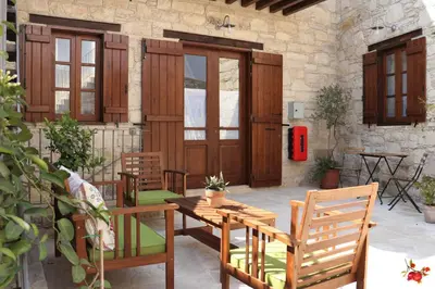 a patio with a table and chairs and a building at Rothkia's Home in Parekklisha