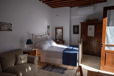 a bedroom with a bed and a couch and a chair at Rothkia's Home in Parekklisha